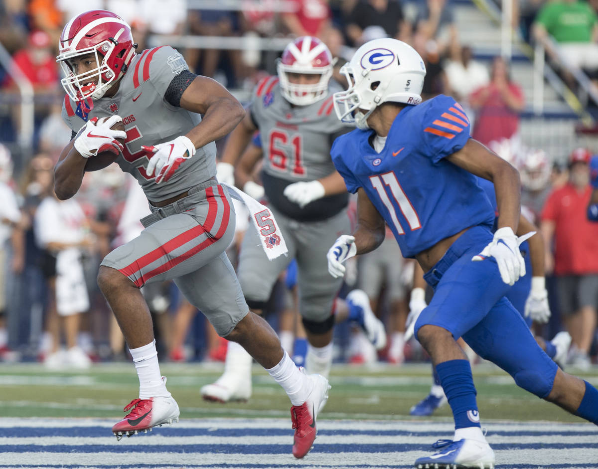 Mater Dei senior wide receiver Bru Mccoy (5) breaks off a big run past Bishop Gorman senior def ...