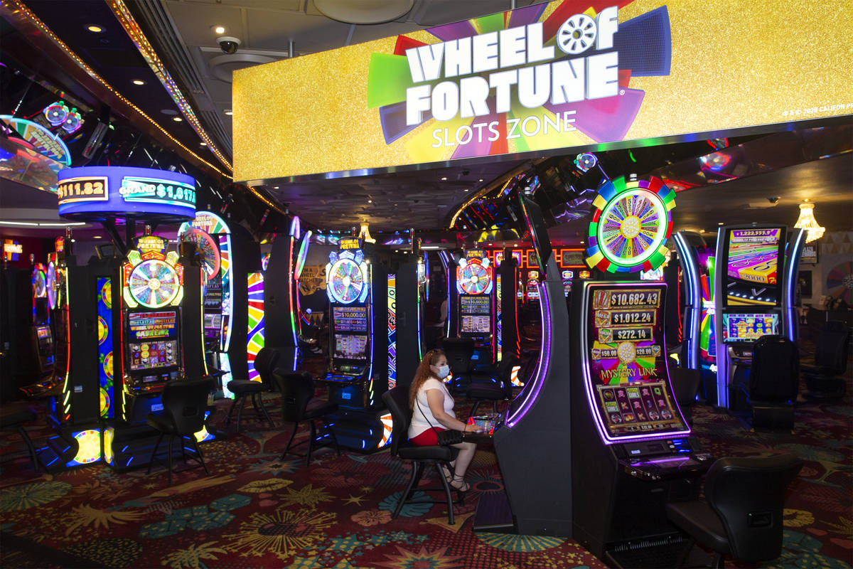 Perla Barragan of San Francisco, Calif., plays a slot machine in the Wheel of Fortune slots zon ...