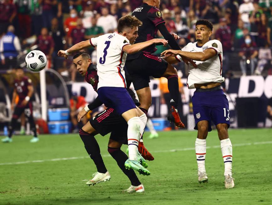 United States defenders Sam Vines (3) and Miles Robinson (12) battle for possession of the ball ...