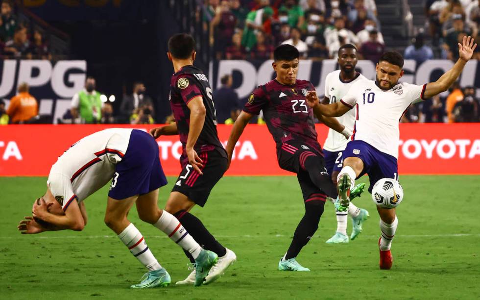 Mexico midfielder Jesus Gallardo (23) and United States midfielder Cristian Roldan (10) fight f ...