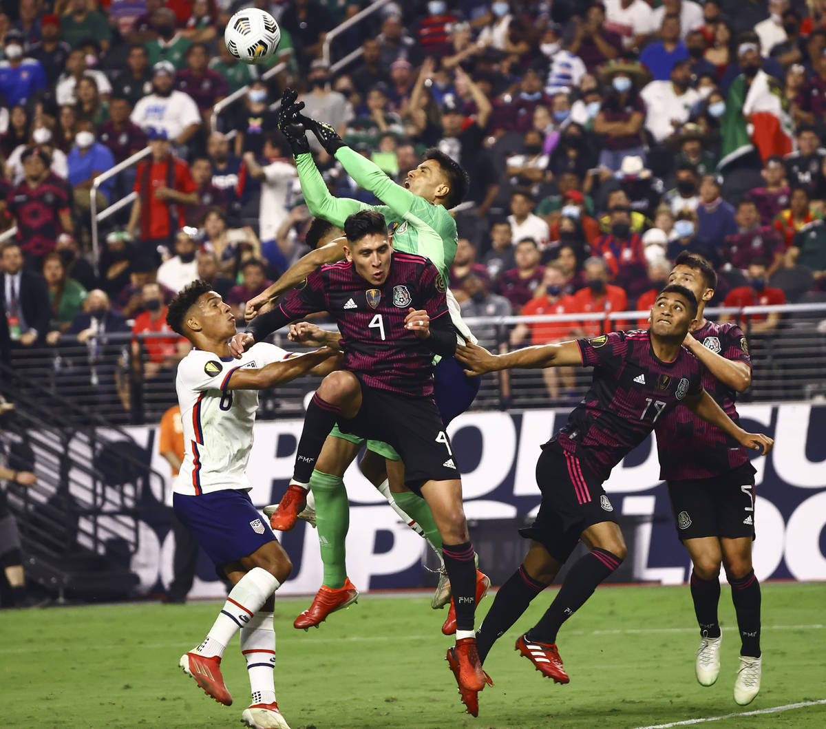 Mexico goalkeeper Alfredo Talavera blocks the ball between United States forward Nicholas Gioac ...