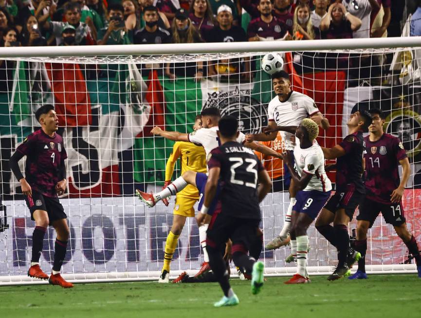 United States defender Reggie Cannon (2) heads the ball against Mexico during extra time in the ...