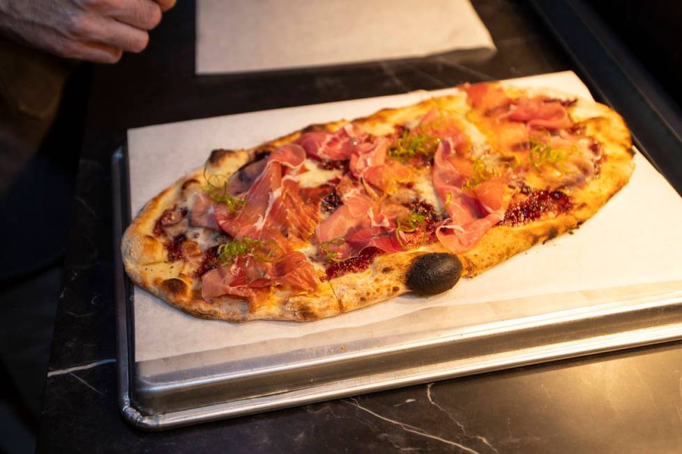 A prosciutto flat bread is prepared at Olives restaurant inside of Virgin Hotels Las Vegas in L ...