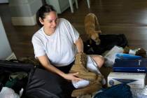 Michelee Quiroz Cruz-Crawford puts inserts in her boots while packing for Air Force Guard offic ...