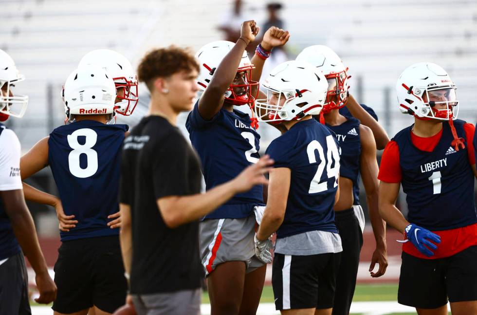 Liberty players, incuding receiver Germie Bernard, huddle during football practice in Henderson ...