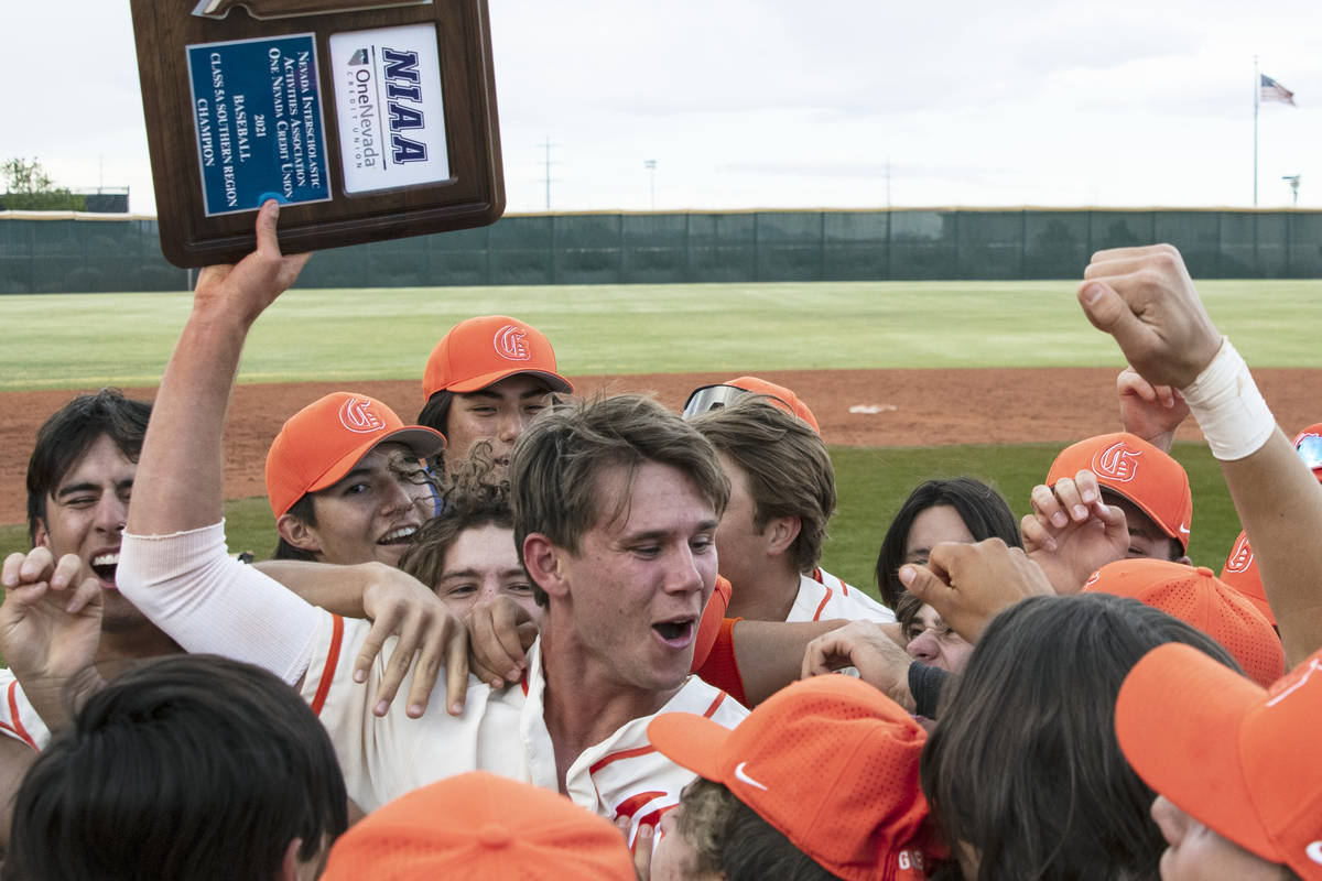 Bishop Gorman HighÕs right fielder Tyler Whitaker joins his teammates as they celebrate th ...