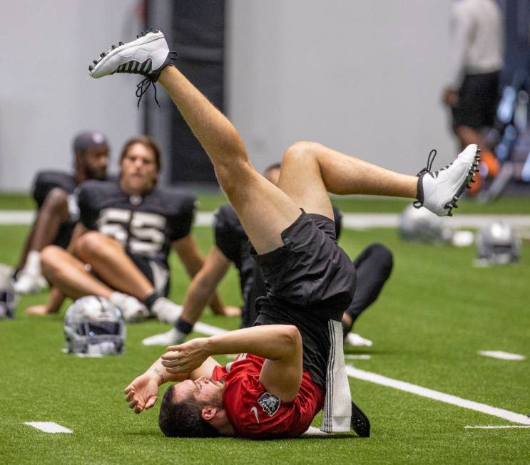 Raiders quarterback Derek Carr (4) does a bicycle kick on his back during practice at the Inter ...