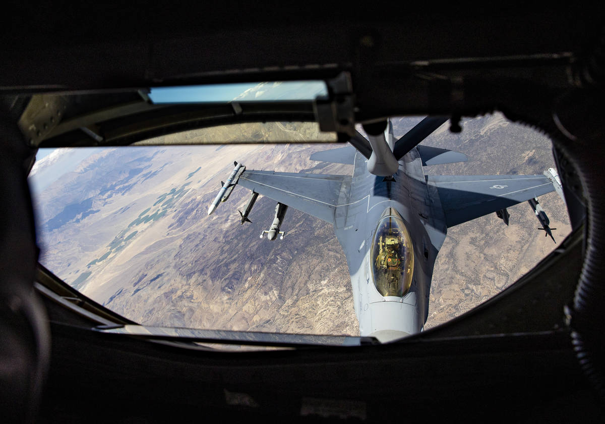 Staff Sgt. Jesse Lee, of the 350th Air Refueling Squadron, left, refuels an F-16 in-flight from ...