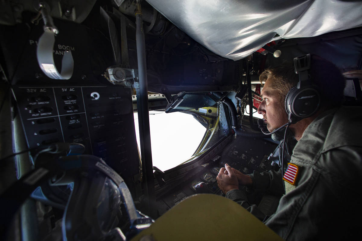 Airman first class Jonathon Covey prepares to refuel an F-16 in-flight from the boom pod of a K ...