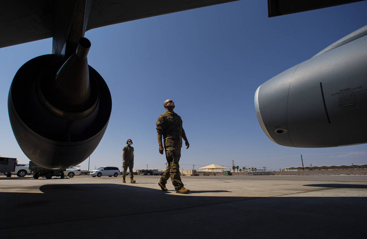 Capt. Chase Cooper, of the 350th Air Refueling Squadron, right, conducts a preflight check befo ...