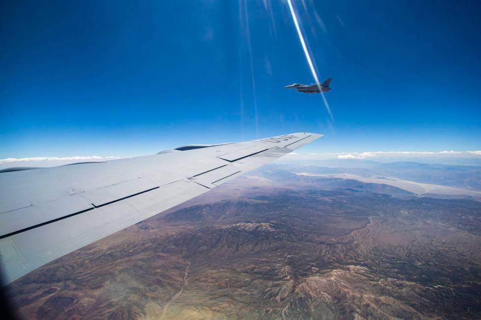 An F-16 flies alongside a KC-135 Stratotanker as it refuels planes around the Nevada Test and T ...