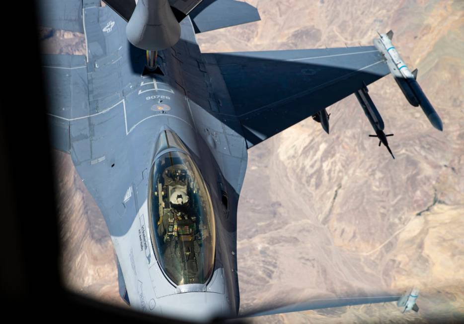 Airman first class Jonathon Covey, not pictured, operates the boom in order to refuel an F-16 i ...