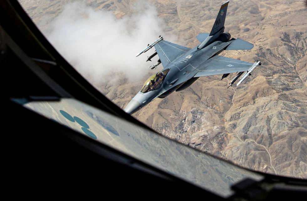 An F-16 is seen after being is refueled in-flight by a KC-135 Stratotanker flying around the Ne ...