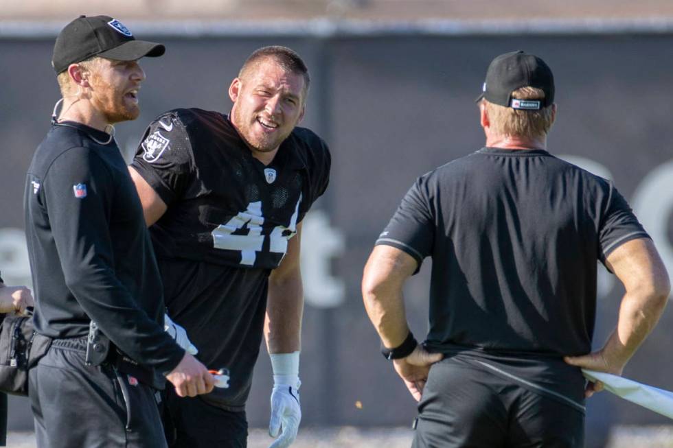 Raiders inside linebacker Nick Kwiatkoski (44, center) talks to Head Coach Jon Gruden, right, a ...