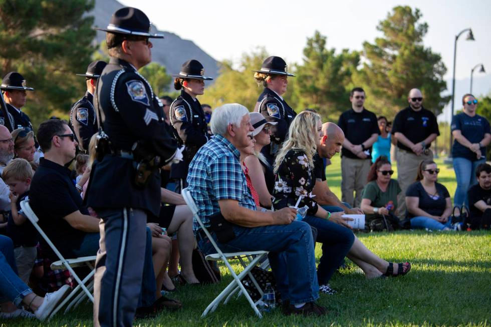 Family, friends and colleagues listen to speakers during a vigil for fallen Nevada Highway Patr ...