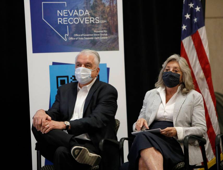 Nevada Gov. Steve Sisolak and Rep. Dina Titus, D-Nev., listen to Nevada State Treasurer Zach Co ...