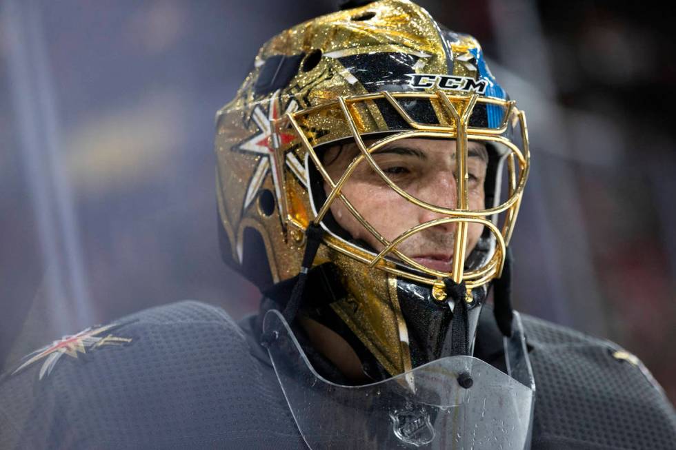 Golden Knights goaltender Marc-Andre Fleury (29) smiles while skating around the net after maki ...