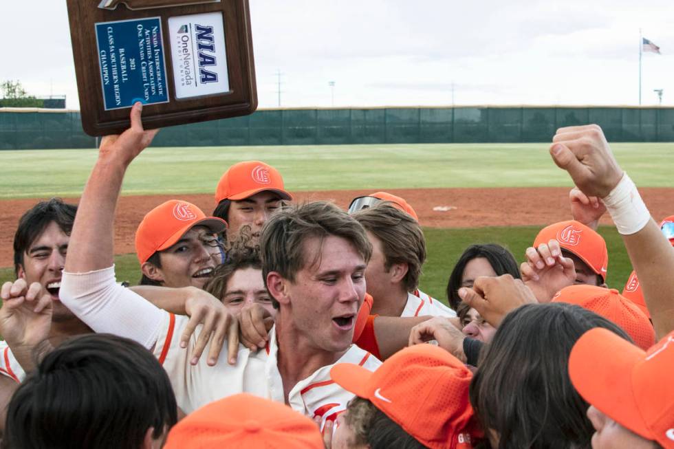 Bishop Gorman HighÕs right fielder Tyler Whitaker joins his teammates as they celebrate th ...