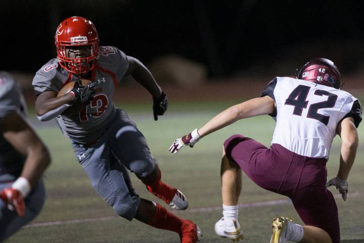 Arbor View sophomore running back D'Andre Washington (13) returns a kick past Faith Lutheran se ...