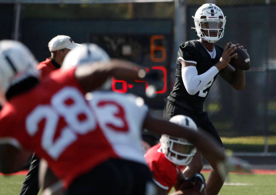 UNLV Rebels quarterback Doug Brumfield (2), right, looks to throw the ball during football prac ...