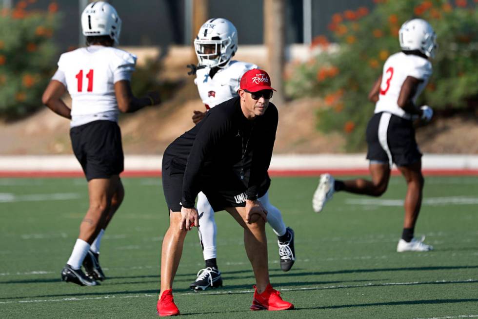 UNLV Rebels head coach Marcus Arroyo watches his players during football practice in UNLV, Wedn ...