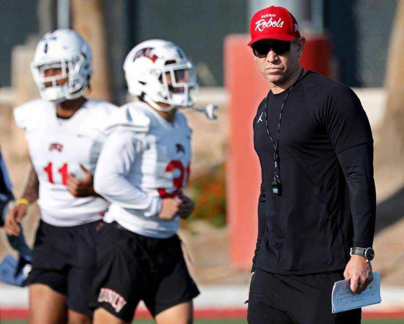 UNLV Rebels head coach Marcus Arroyo watches his players during football practice in UNLV, Wedn ...