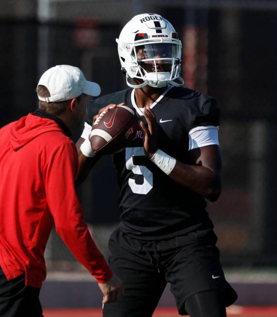 UNLV Rebels quarterback Justin Rogers (5) looks to throw the ball during football practice in U ...