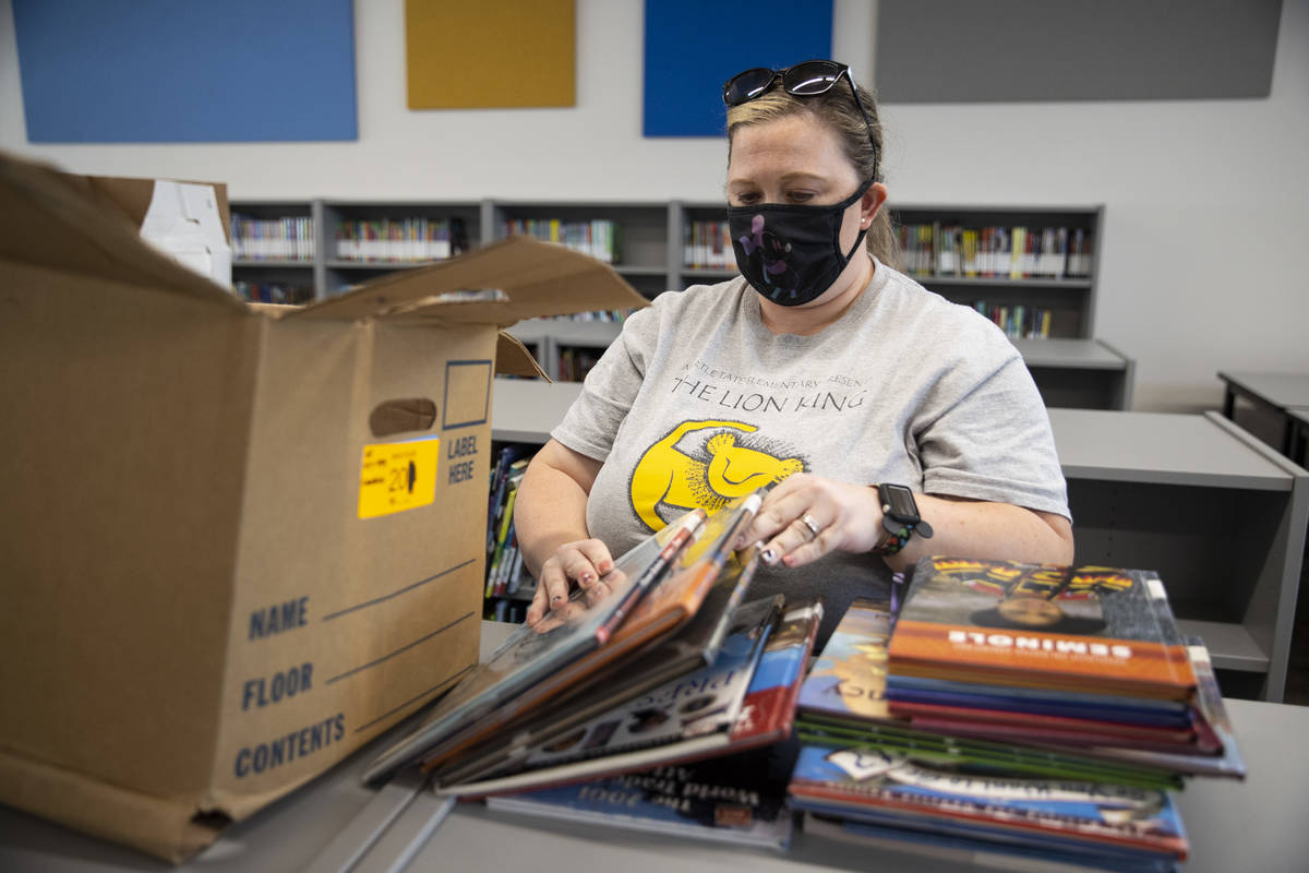Librarian Christina Mehl-Smith organizes books in the library at Tate Elementary School in Las ...