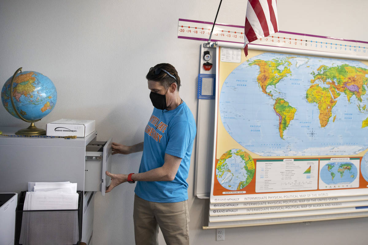 Fifth-grade-teacher Justin Dreyer gets his classroom ready for the new school year Tate Element ...