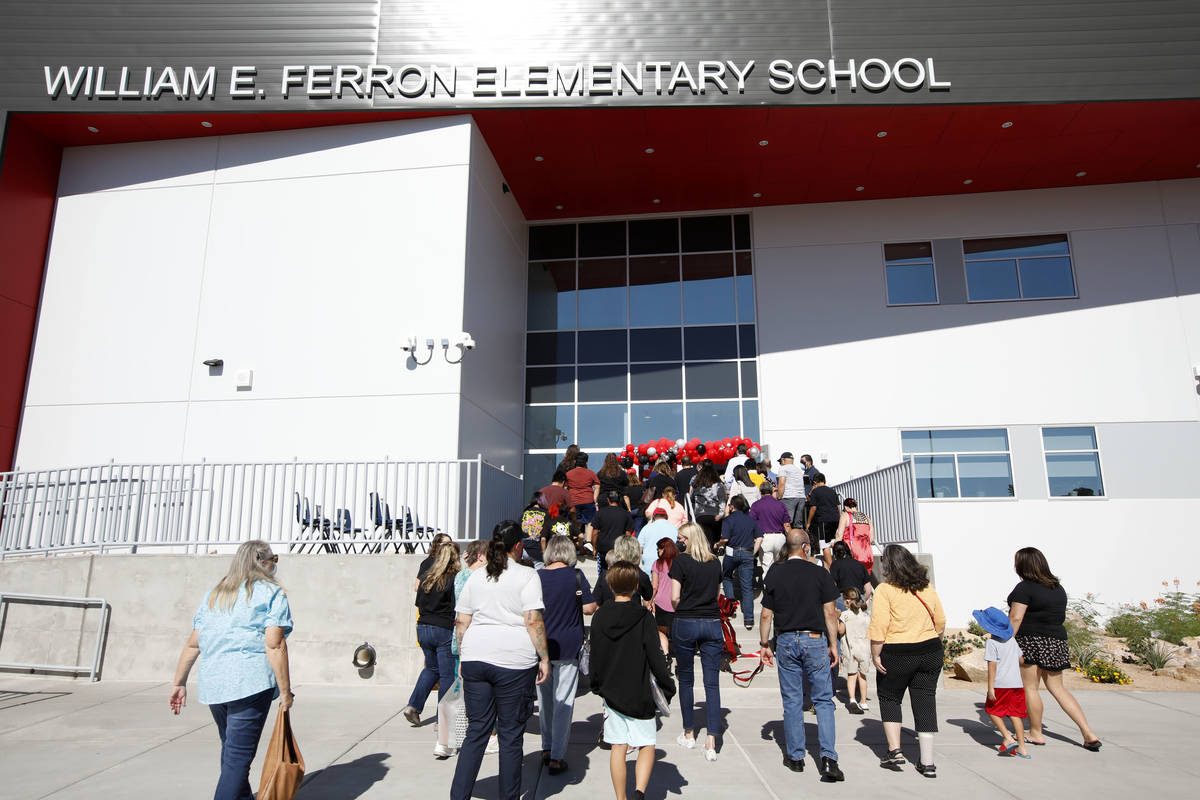 Participants enter the replacement school of Ferron Elementary School after a ribbon cutting c ...