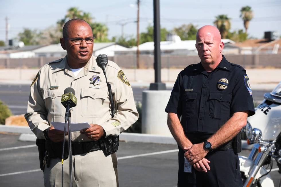 Metropolitan Police Department Capt. Carlos Hank addresses the media next to Bryan Zink, public ...