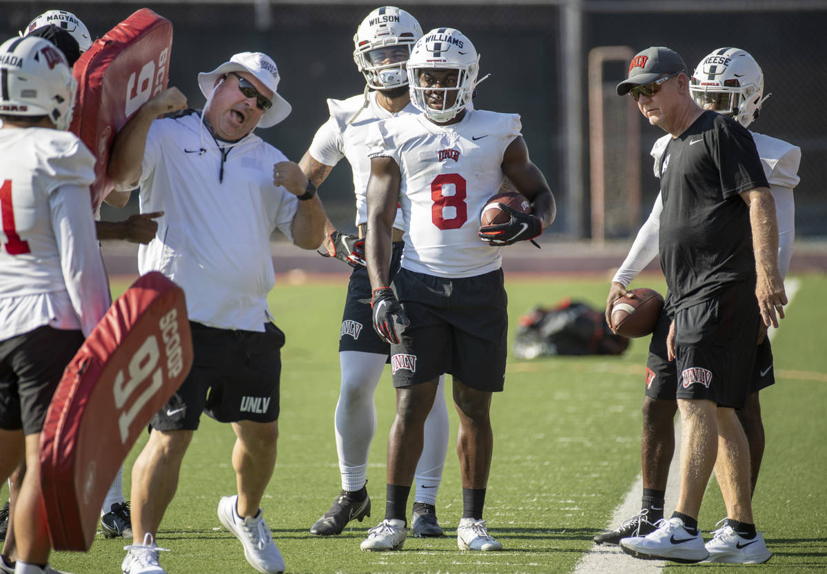 UNLV running back Charles Williams (8) watches as a coach explains a drill during football team ...