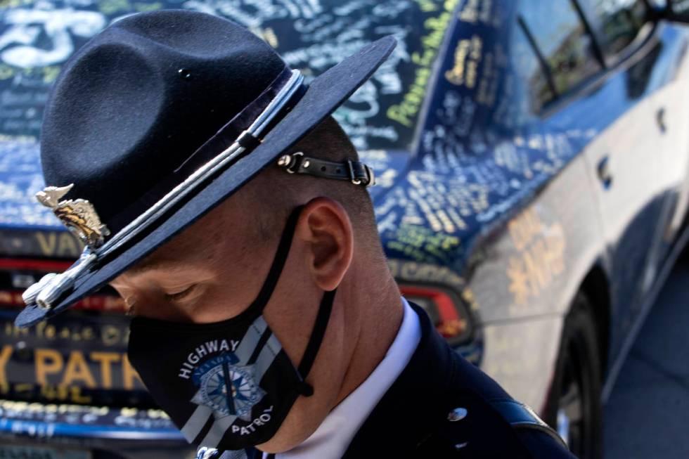 A member of the Nevada Highway Patrol makes way into fallen trooper Micah May's memorial servic ...