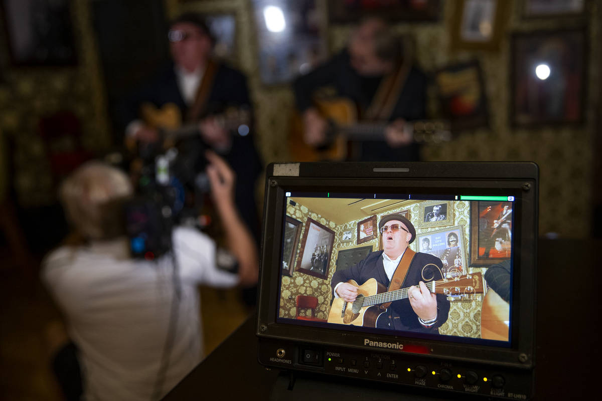 Dave Rooney of The Black Donnellys, a local Irish music duo, plays while filming a documentary ...