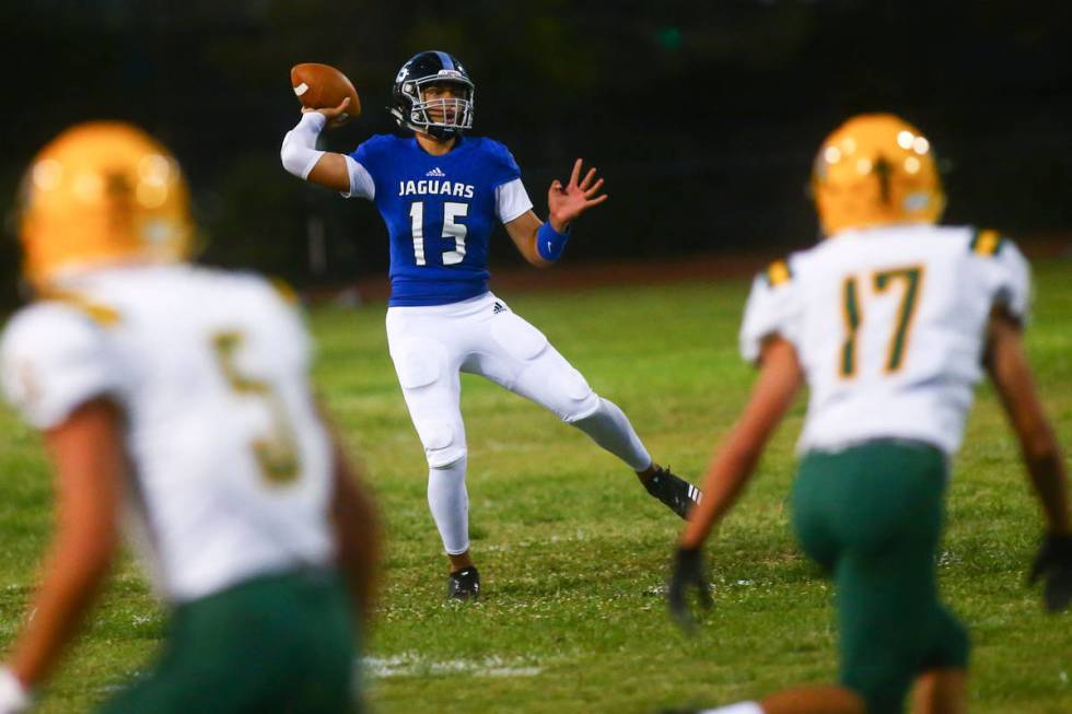 Desert Pines' Rjay Tagataese (15) looks to pass during the first half of a football game agains ...