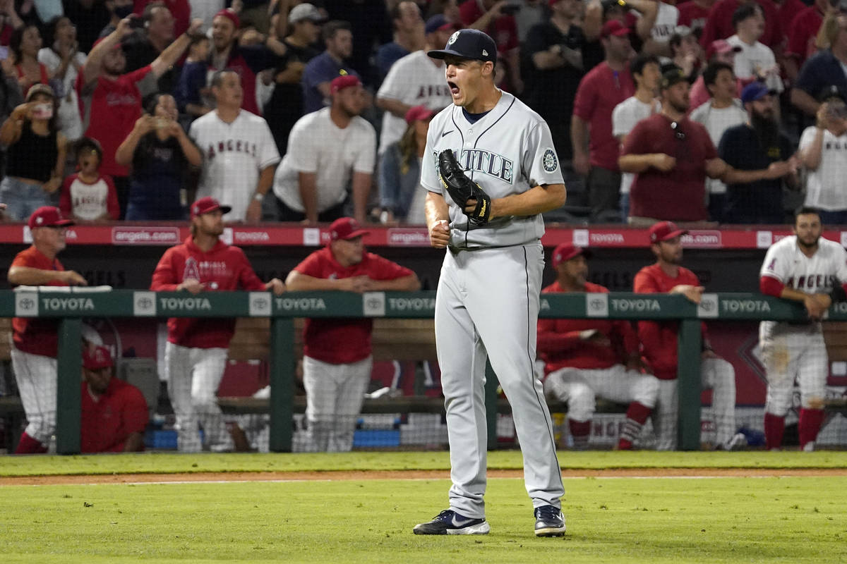 Seattle Mariners relief pitcher Paul Sewald celebrates as the final out is made to end their ba ...