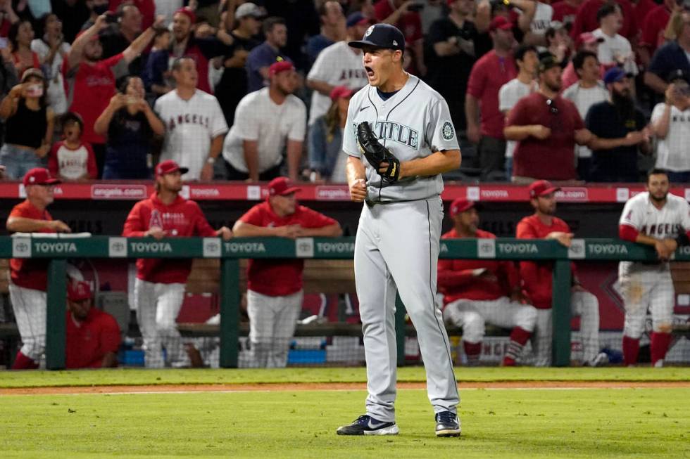 Seattle Mariners relief pitcher Paul Sewald celebrates as the final out is made to end their ba ...