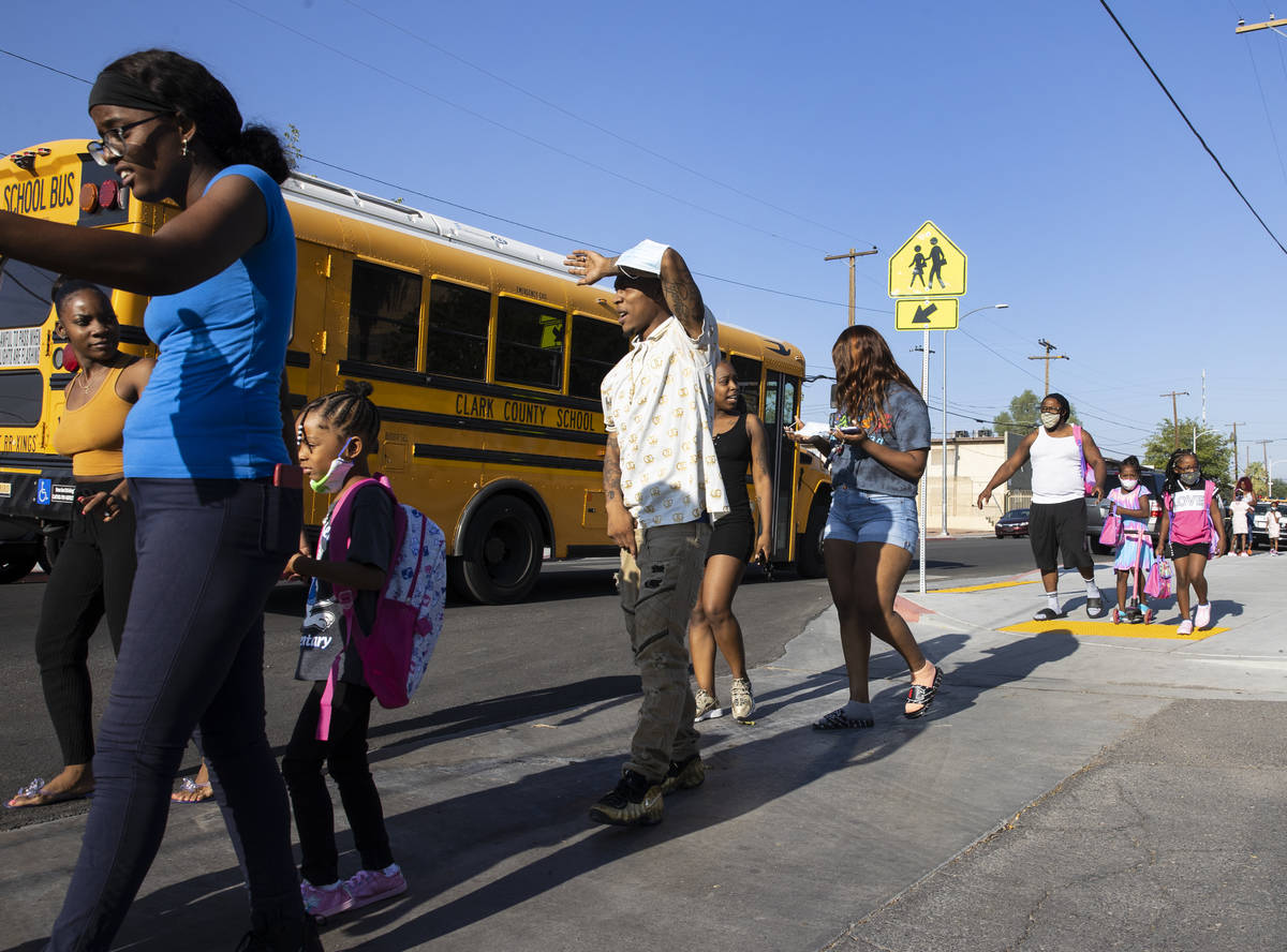 Kelly Elementary Community School students and their parents arrive to attend their first day o ...