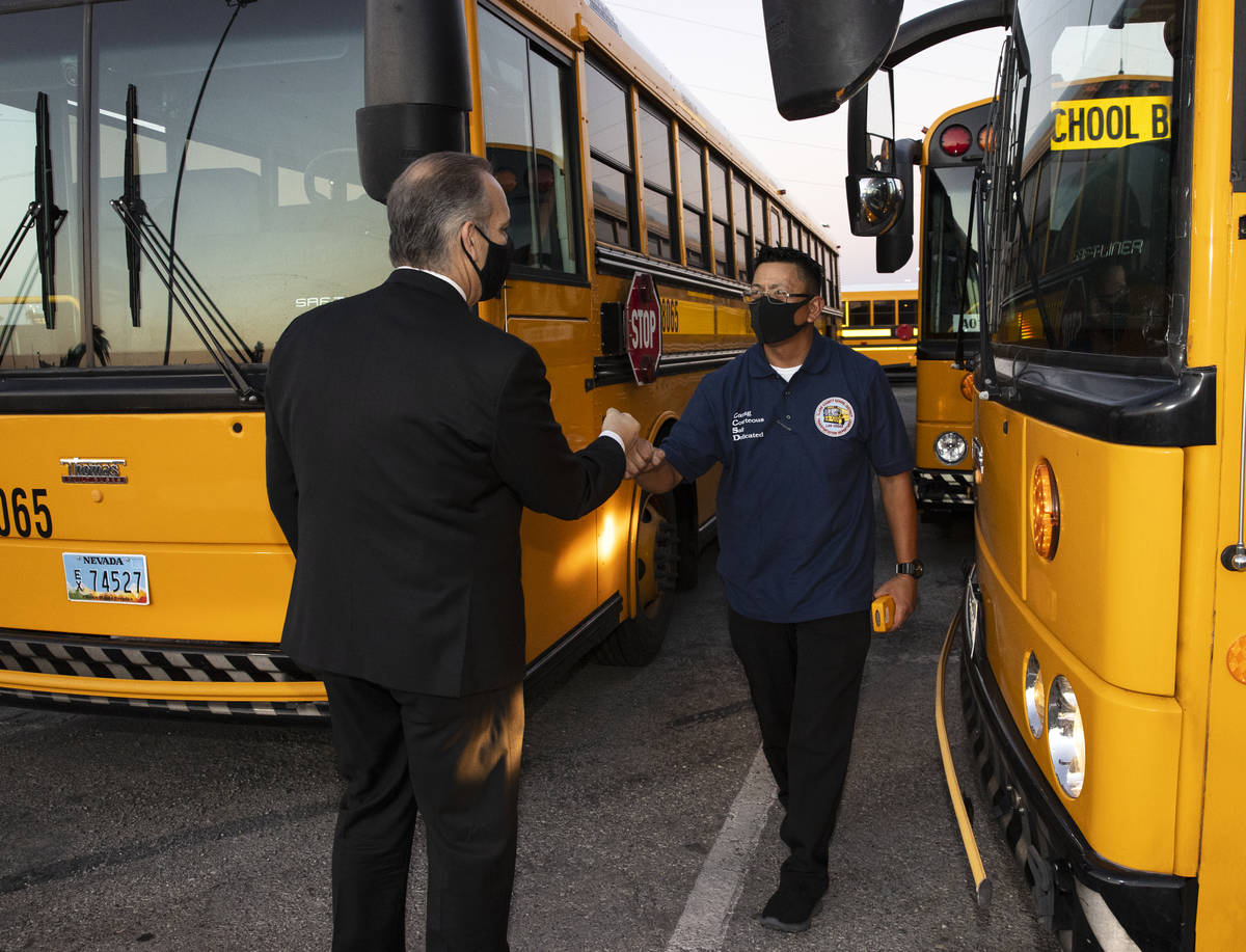 Arvin Tanada, a bus driver with the Clark County School District, fist pump with Superintendent ...