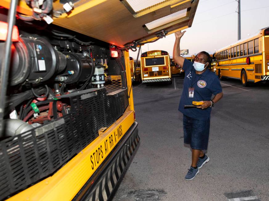 Patricia Wallace, a bus driver with the Clark County School District, inspects her bus at Arvil ...
