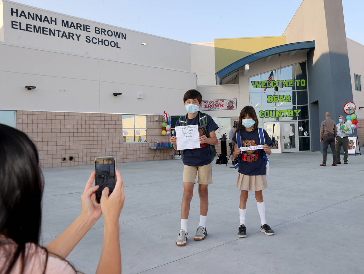Melissa Brimmer of Henderson takes a photo of her children Trey, 9, and Bella, 8, on the first ...