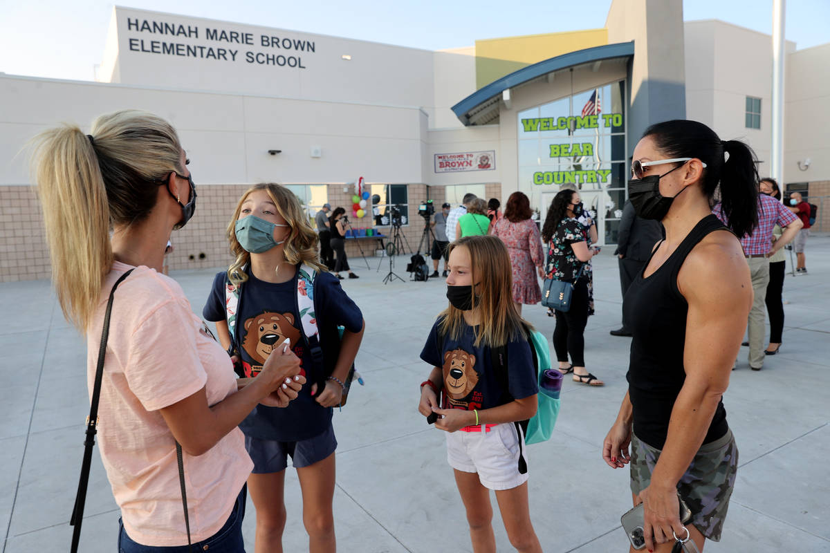 Alabama Buckmeyer, second from left, 10, talks to her mother Brianna as Reagan Menard, 10, and ...
