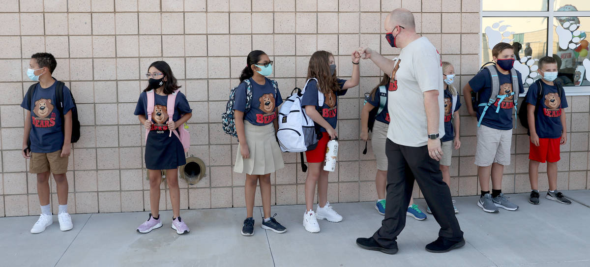 Assistant Principal Matthew Christian greets fifth-grader Khloe Chairez and other student ambas ...