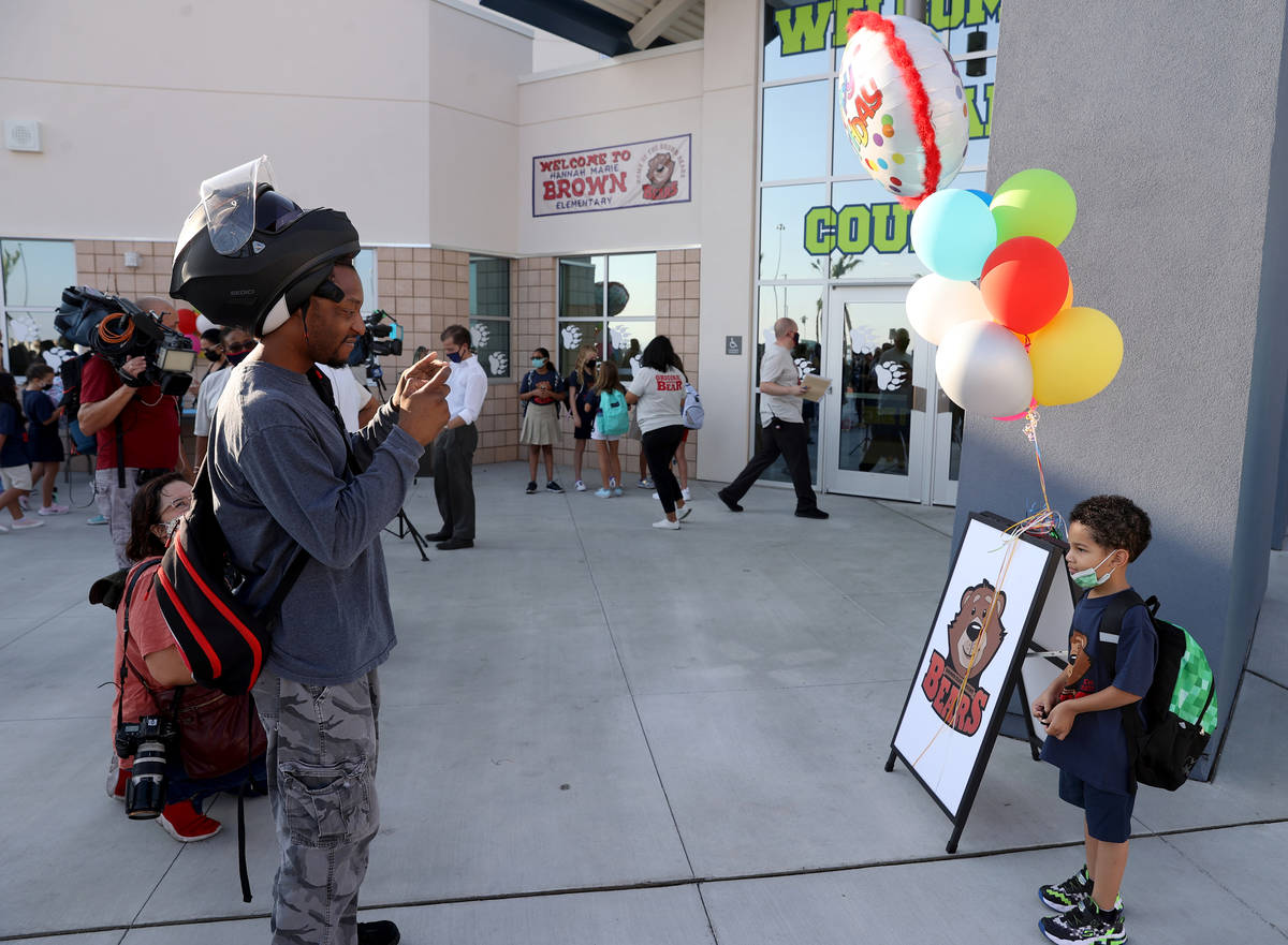 Sean Wiseman takes a photo of his son Quinn, 5, after a ribbon-cutting ceremony on the first da ...