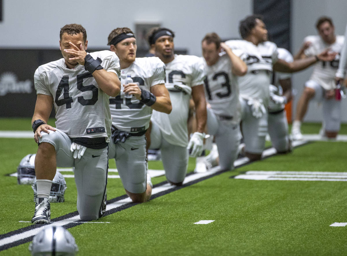 Raiders fullback Alec Ingold (45) wipes his face while stretching during practice at the Interm ...