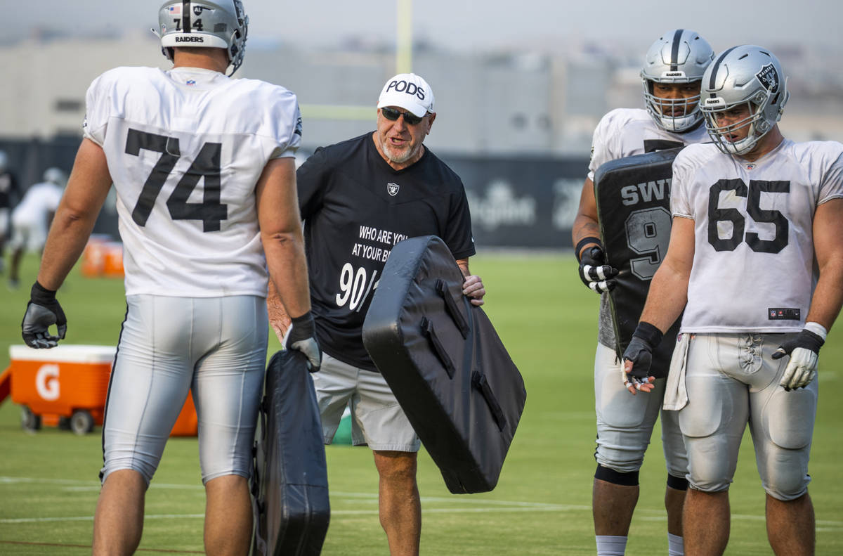 Raiders offensive line coach Tom Cable gives instructions to Raiders offensive tackle Kolton Mi ...