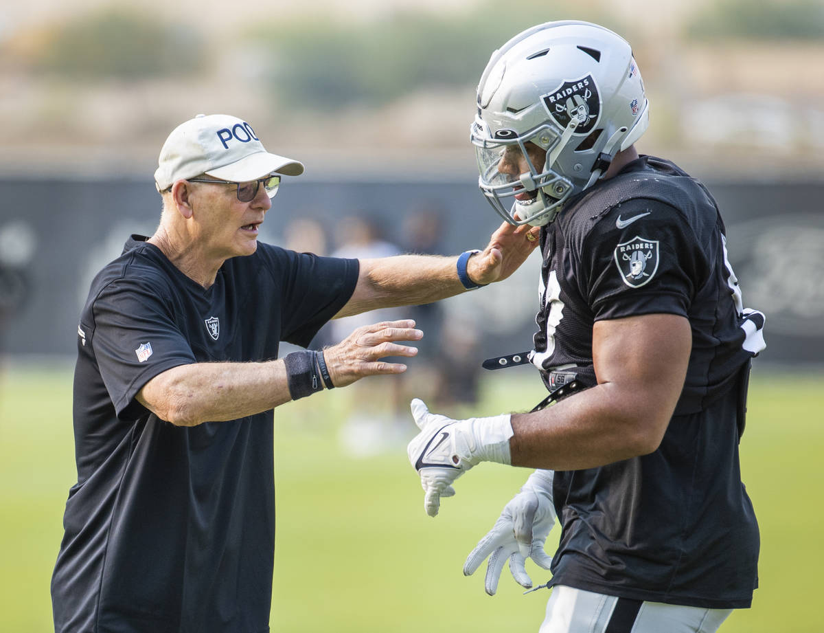 Raiders defensive line coach Rod Marinelli confers with Raiders defensive end Solomon Thomas (9 ...