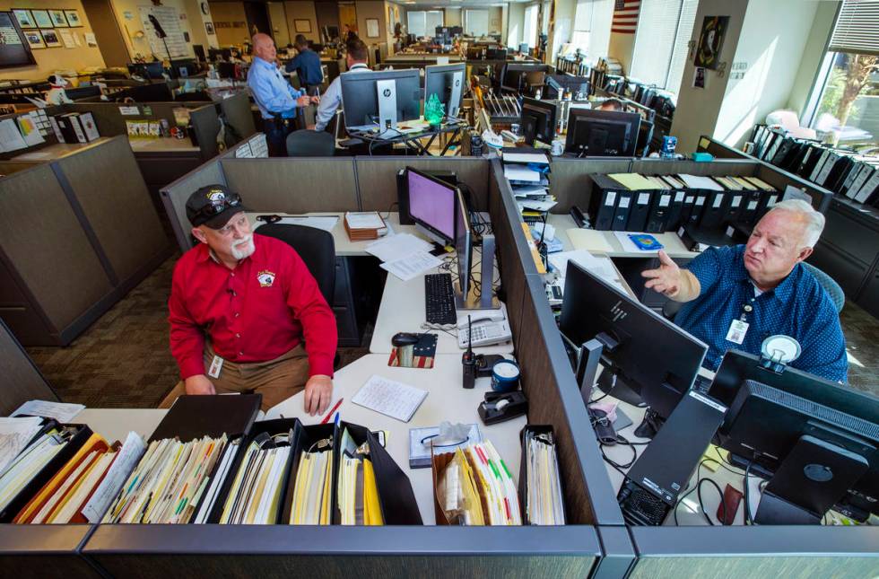 Metropolitan Police Department cold case detectives Dan Long, left, and Kenneth Hefner confer f ...