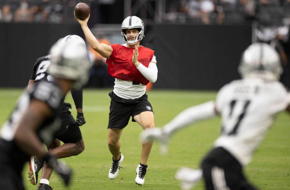 Raiders quarterback Derek Carr (4) makes a sideline throw to Raiders wide receiver Henry Ruggs ...