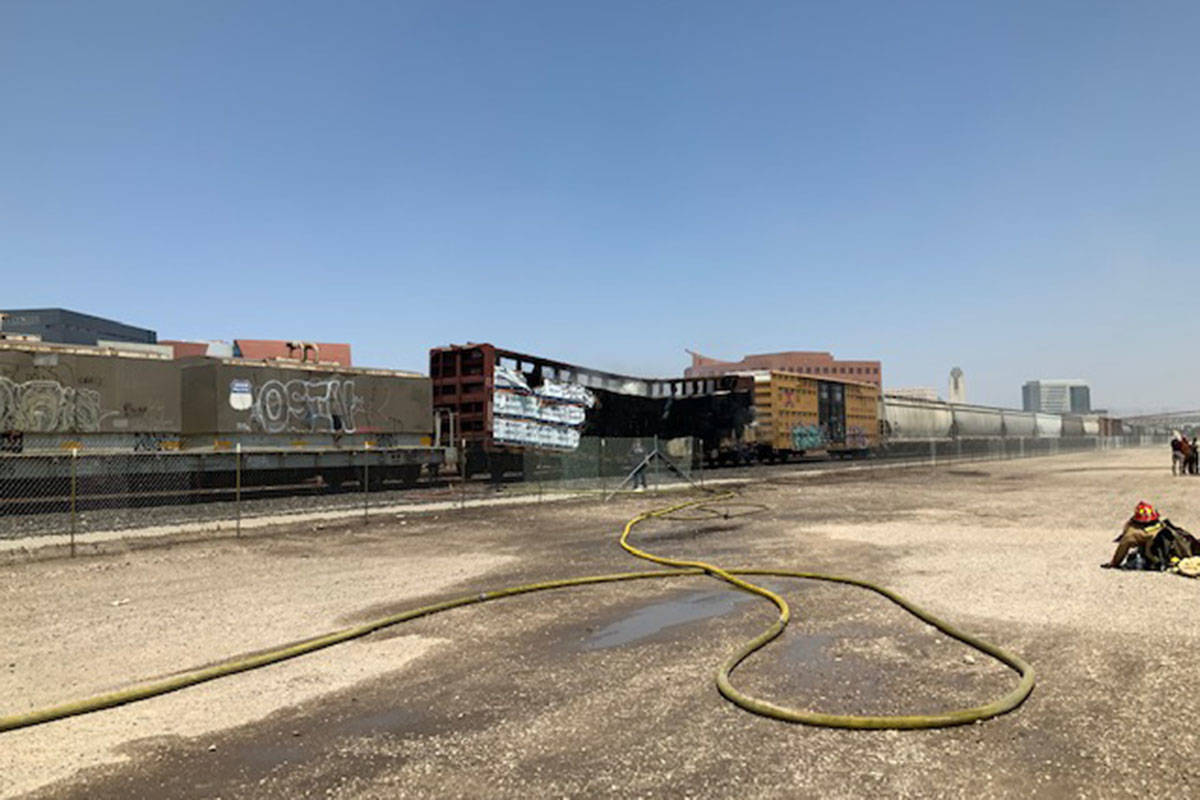 Crews battle a flatbed rail car Sunday, Aug. 8, 2021, at 926 S. Commerce St. in Las Vegas. (La ...